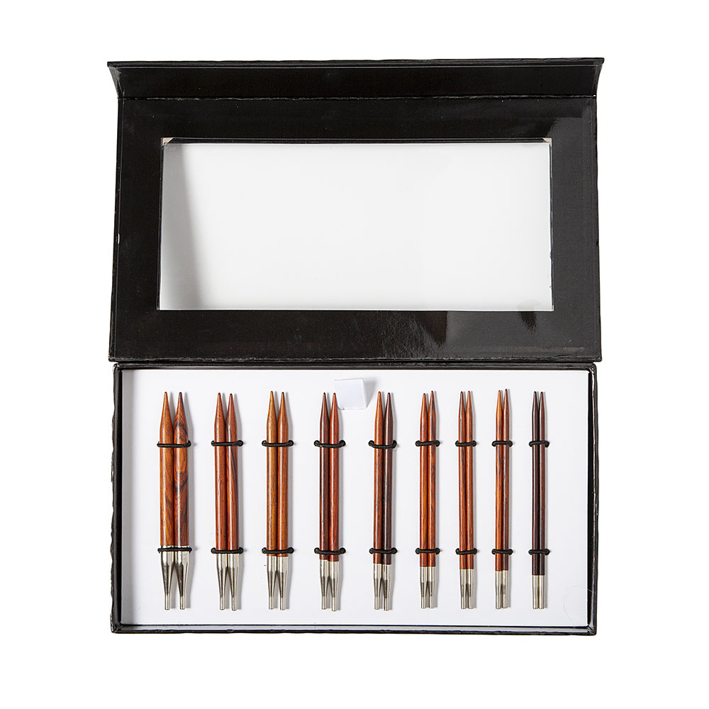 A set of wooden circular interchangeable knitting needles in a black presentation box